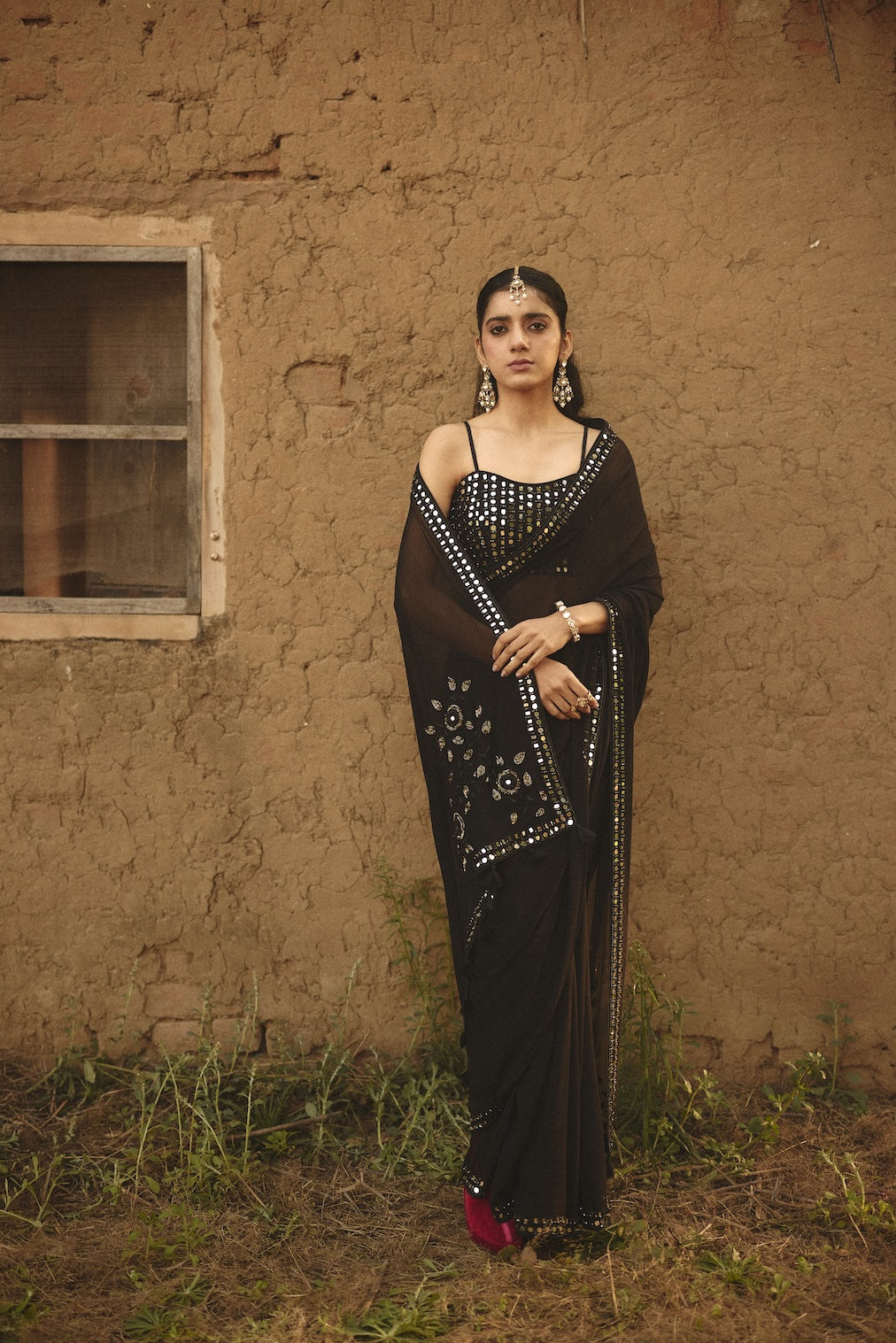 SARMAYA black chiffon saree with floral motifs by Rashika Mittal - front view