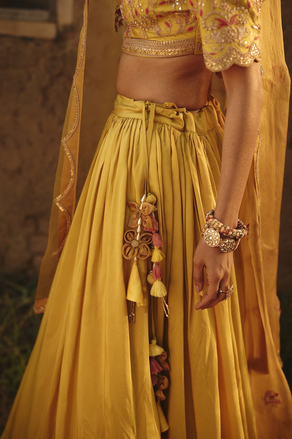 DRITI & HESYRA yellow silk lehenga with floral motifs by Rashika Mittal - full silhouette