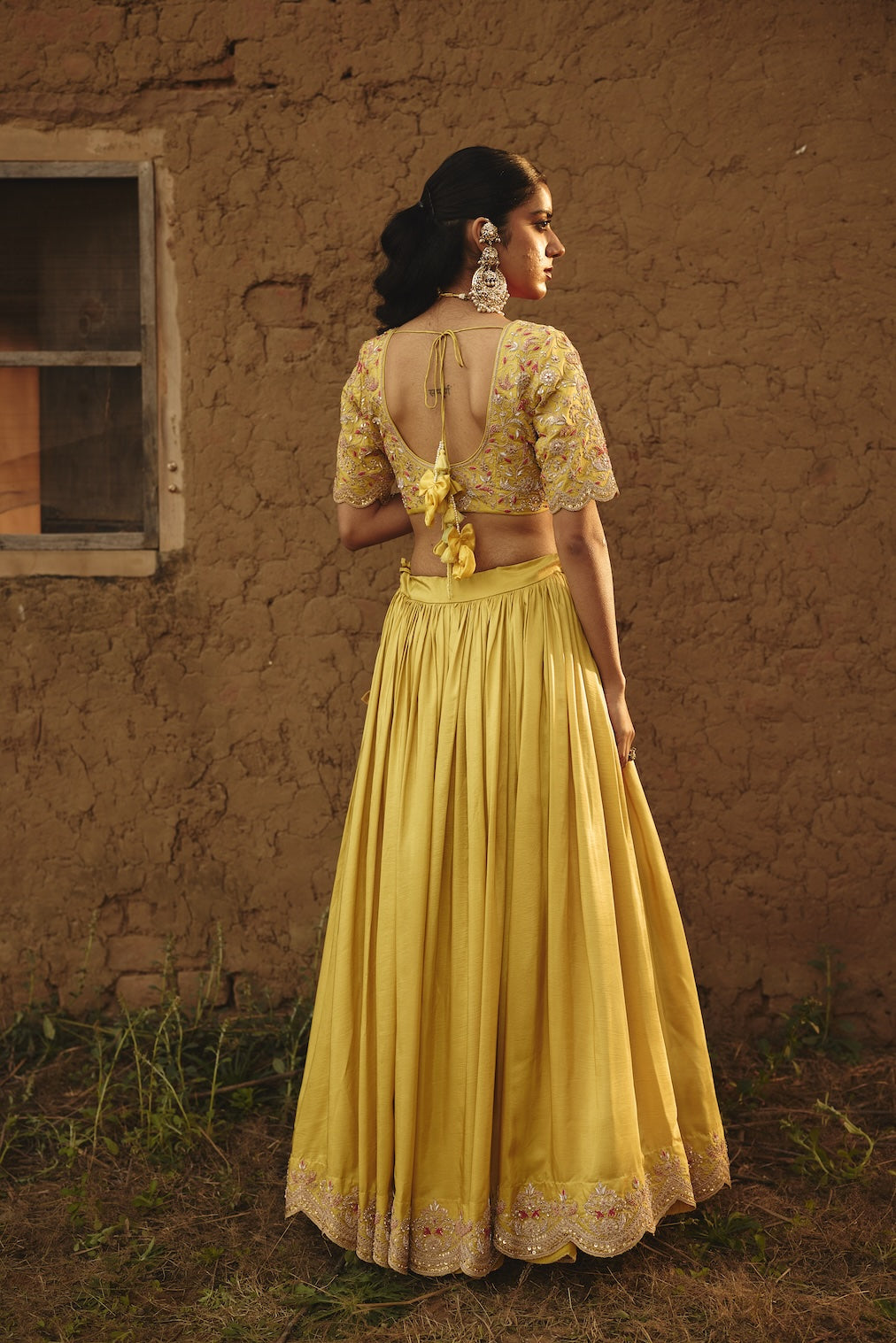 DRITI & HESYRA yellow silk lehenga with floral motifs by Rashika Mittal - back view